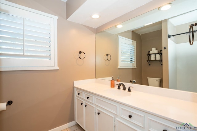 bathroom featuring tile patterned flooring, vanity, and toilet