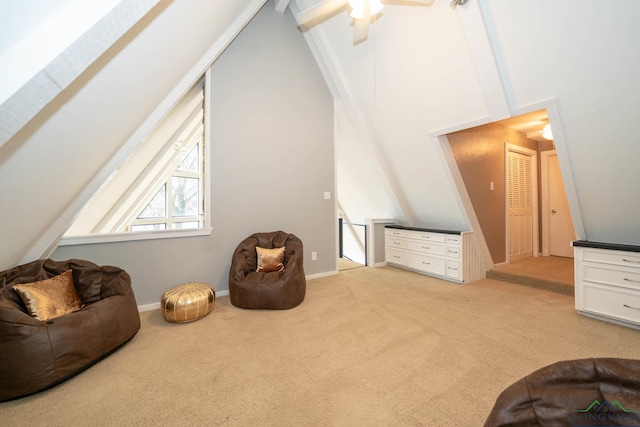 sitting room featuring ceiling fan, beamed ceiling, high vaulted ceiling, and light colored carpet