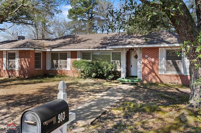 ranch-style home featuring brick siding