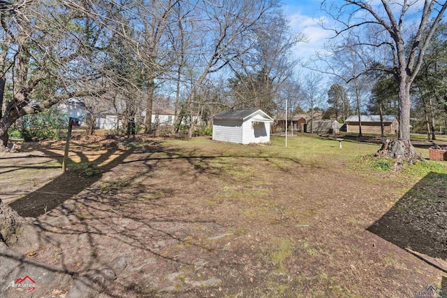 view of yard with an outdoor structure and a shed