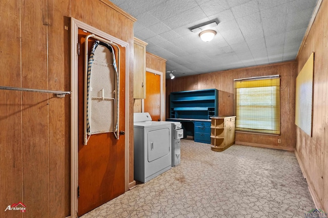 kitchen featuring washer / dryer, wooden walls, visible vents, and tile patterned floors