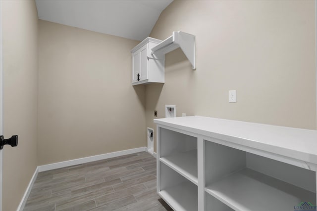 washroom with washer hookup, electric dryer hookup, and cabinets