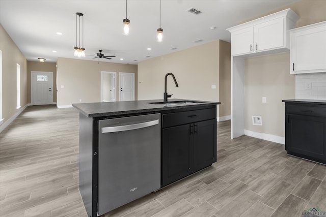 kitchen featuring ceiling fan, a center island with sink, stainless steel dishwasher, sink, and white cabinetry