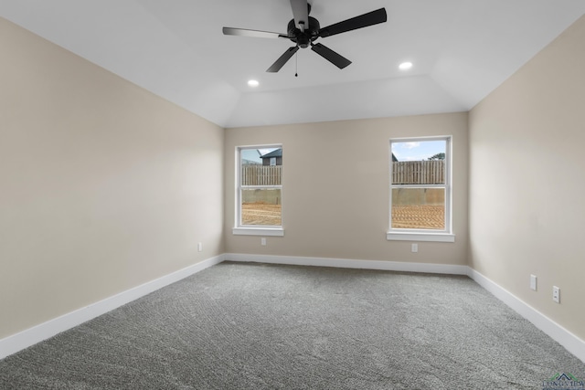 carpeted empty room with ceiling fan and vaulted ceiling