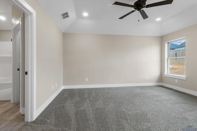 interior space featuring ceiling fan, vaulted ceiling, and carpet floors