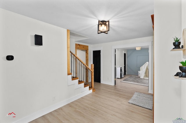 hallway with light hardwood / wood-style flooring