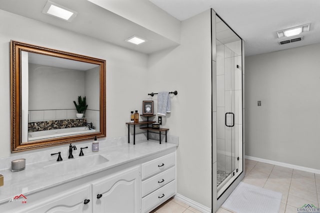 bathroom featuring tile patterned flooring, vanity, and separate shower and tub