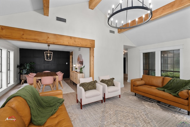 living room featuring beam ceiling, high vaulted ceiling, wood-type flooring, and a notable chandelier