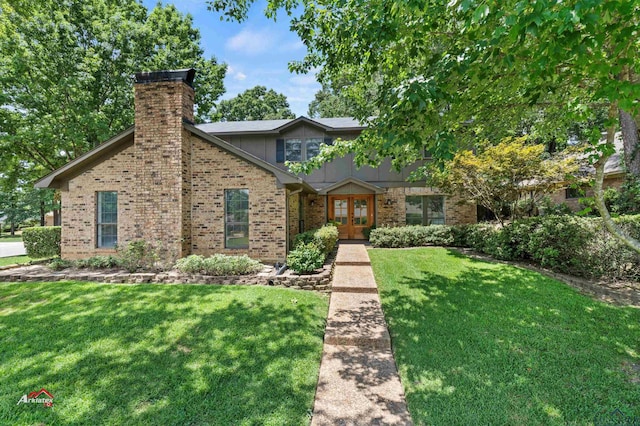 view of front of house with french doors and a front lawn