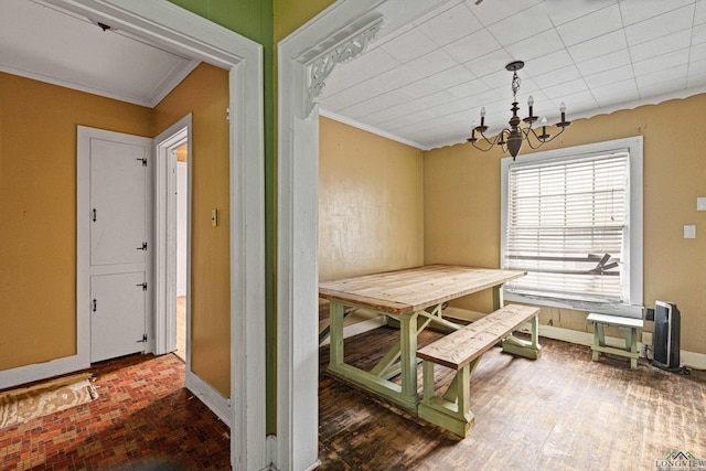 2707 Dudley Rd, Kilgore, TX 75662 - dining area with ornamental molding, a chandelier, and brick patterned floors