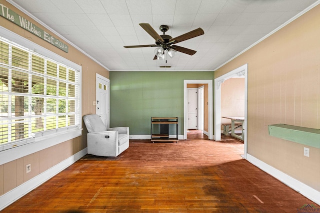 2707 Dudley Rd, Kilgore, TX 75662 - spare room with ornamental molding, a ceiling fan, and hardwood / wood-style flooring