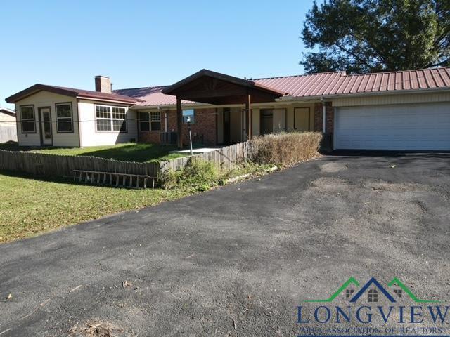 ranch-style house with a garage and a front lawn