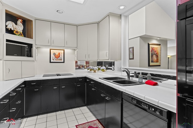 301 Tealwood Dr, Longview, TX 75605 - kitchen featuring black appliances, a sink, light tile patterned flooring, dark cabinetry, and white cabinets