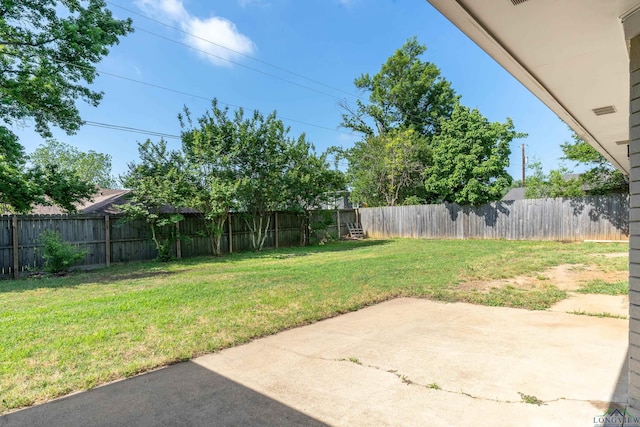 view of yard featuring a patio area and a fenced backyard