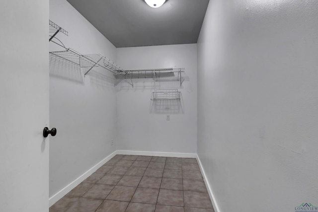 spacious closet with tile patterned floors