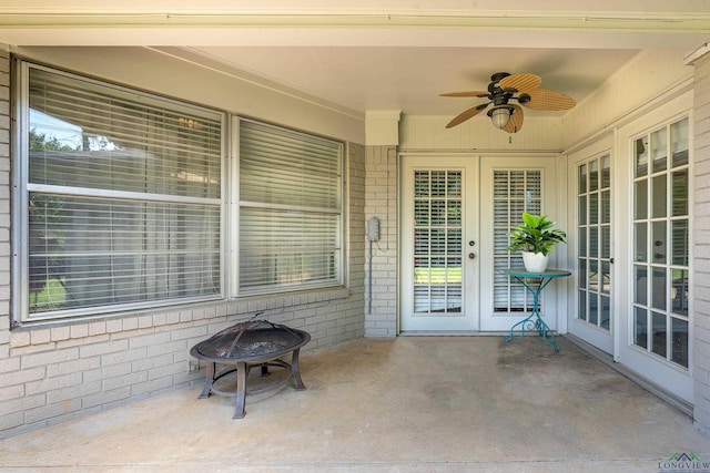 view of patio with ceiling fan and an outdoor fire pit
