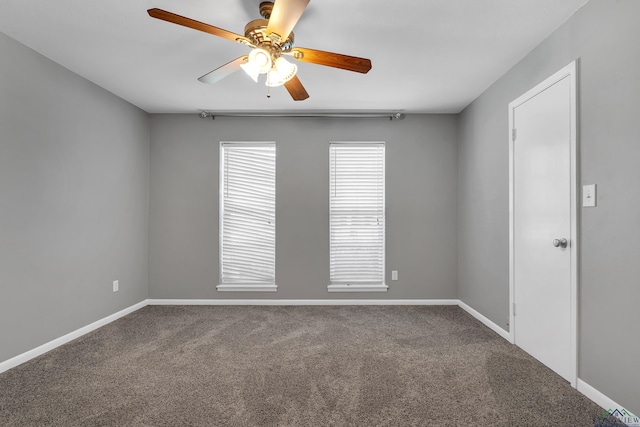 carpeted empty room with a ceiling fan and baseboards