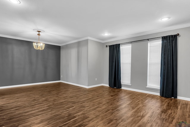 empty room with a notable chandelier, baseboards, crown molding, and dark wood-style floors