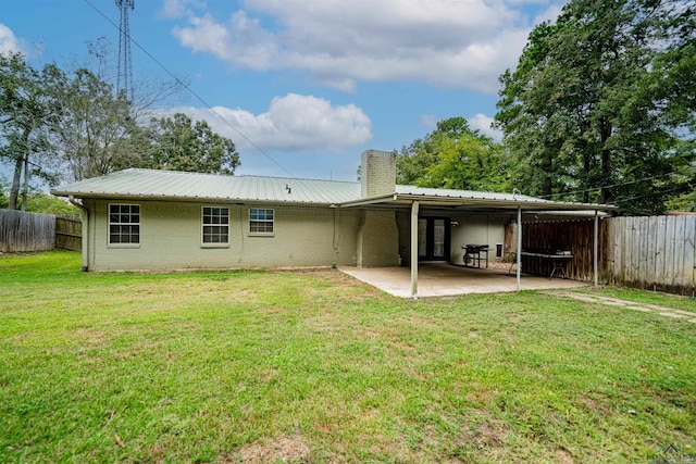 rear view of house featuring a yard and a patio area