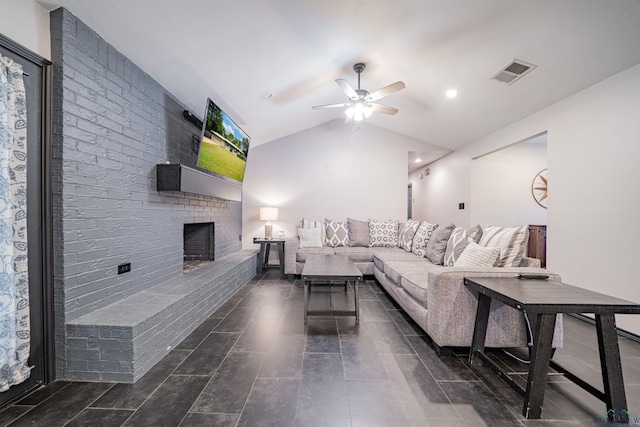 living room with ceiling fan, lofted ceiling, and a brick fireplace