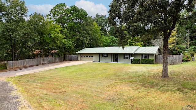 ranch-style house featuring a garage and a front yard