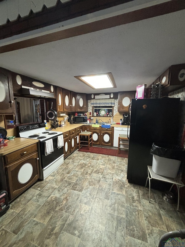 kitchen featuring dark brown cabinetry and white appliances