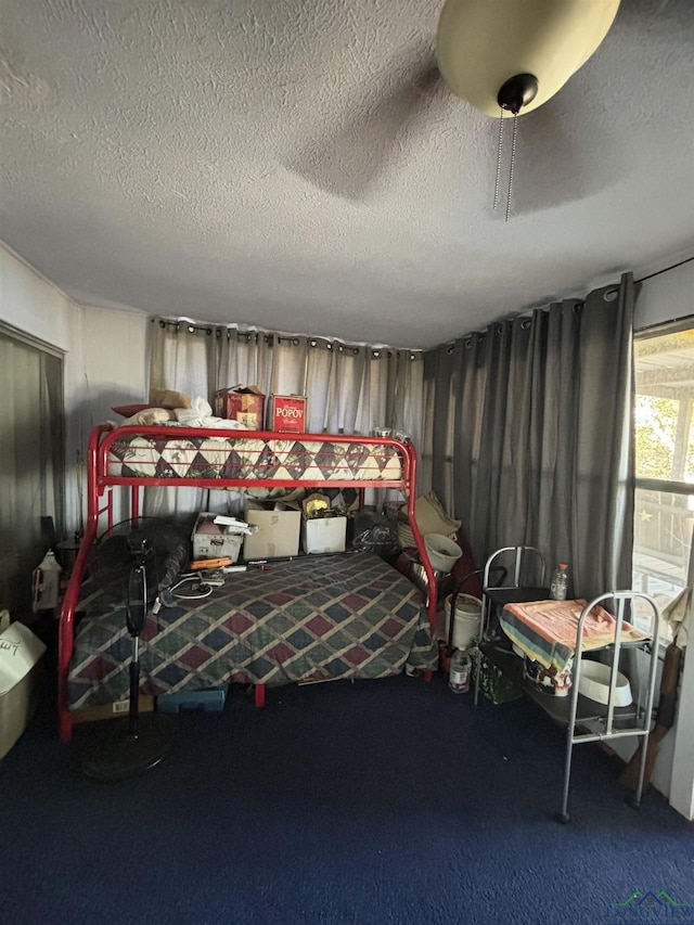 carpeted bedroom featuring a textured ceiling