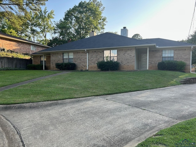 811 Georgia Ln, Longview, TX 75604 - single story home featuring brick siding, a chimney, and a front lawn
