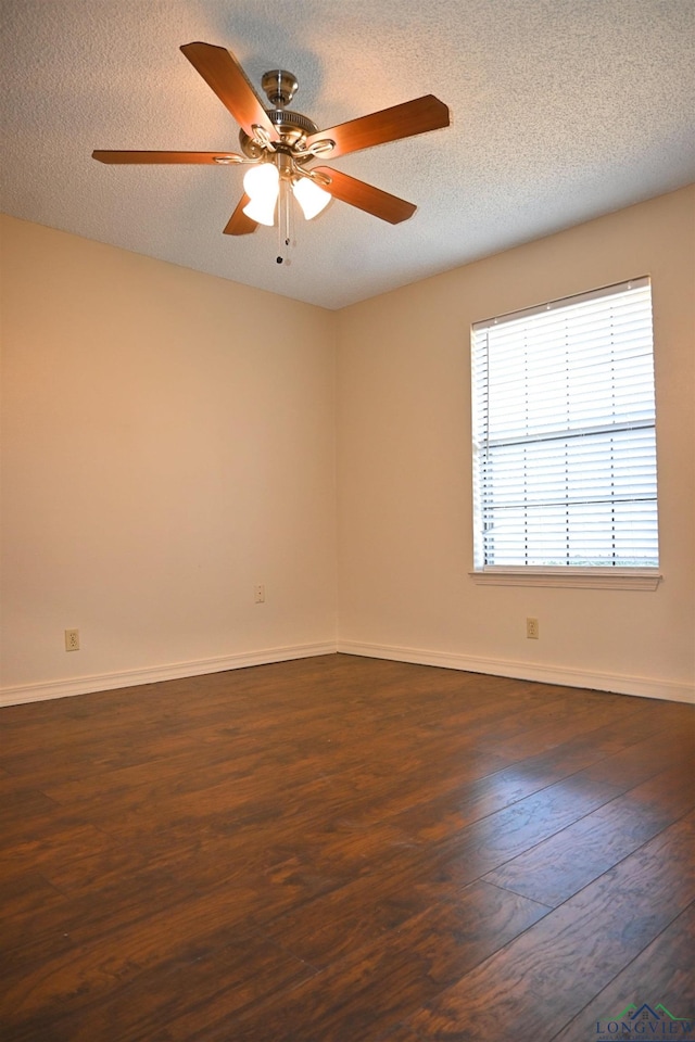 811 Georgia Ln, Longview, TX 75604 - unfurnished room featuring dark wood-style flooring, ceiling fan, and a textured ceiling