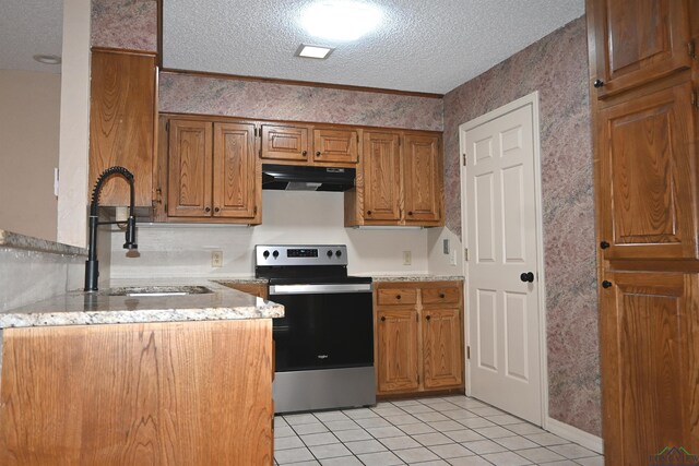811 Georgia Ln, Longview, TX 75604 - kitchen featuring stainless steel electric stove, under cabinet range hood, a textured ceiling, brown cabinetry, and light tile patterned floors