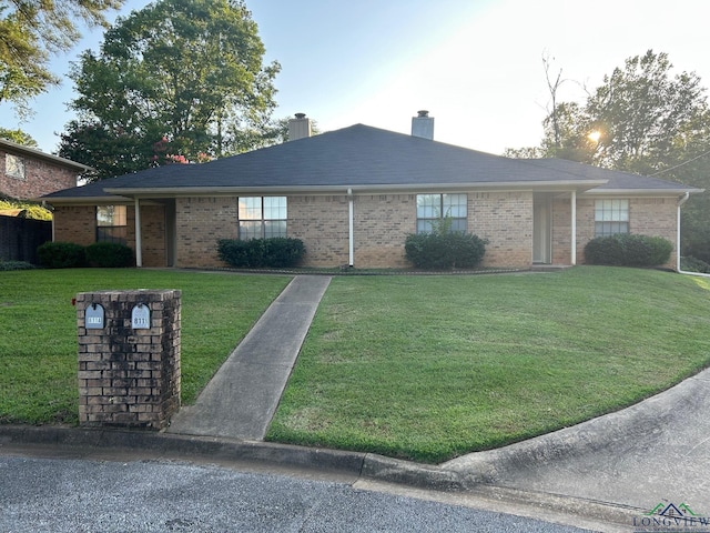 811 Georgia Ln, Longview, TX 75604 - ranch-style home with a chimney, a front yard, and brick siding