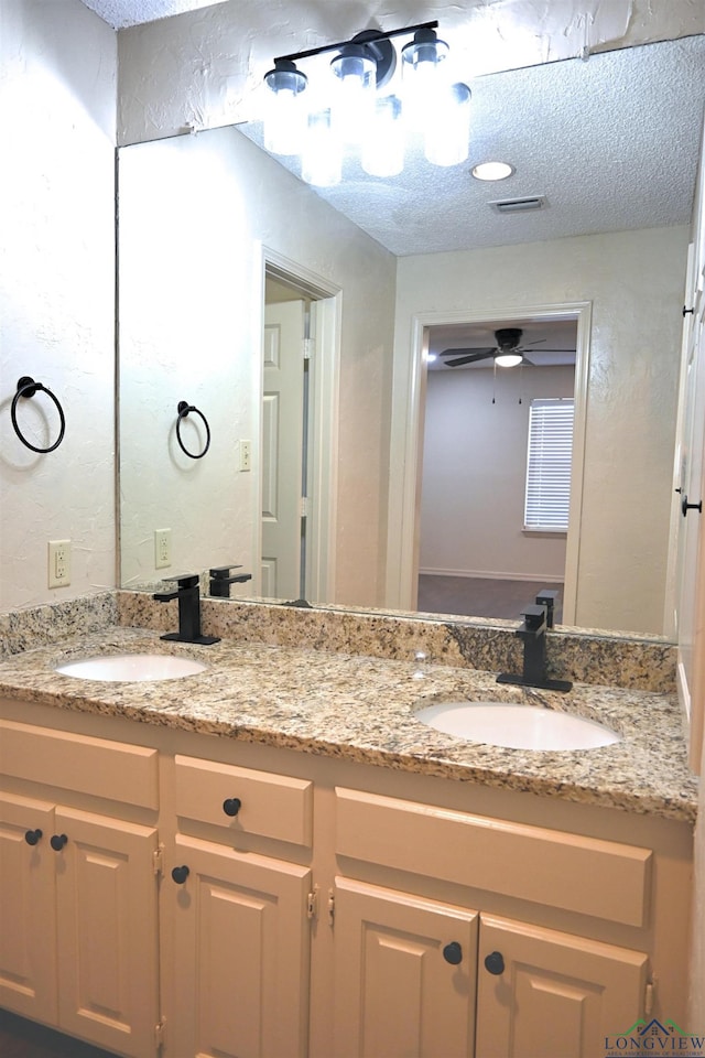 811 Georgia Ln, Longview, TX 75604 - bathroom featuring double vanity, a textured ceiling, and ceiling fan