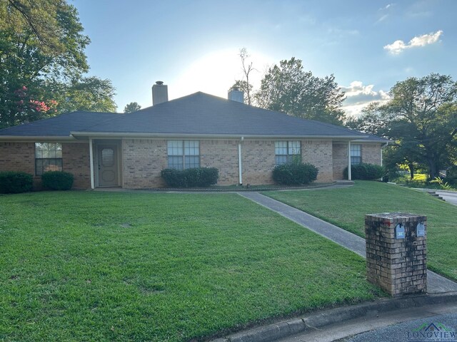 811 Georgia Ln, Longview, TX 75604 - ranch-style home featuring a front yard, a chimney, and brick siding