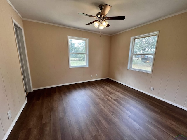 empty room featuring ceiling fan, dark hardwood / wood-style flooring, and ornamental molding