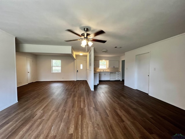 unfurnished living room with ceiling fan, dark hardwood / wood-style flooring, and a healthy amount of sunlight