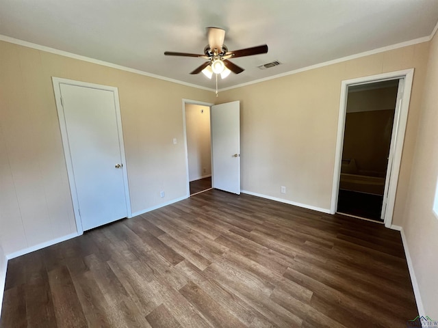 unfurnished bedroom with ornamental molding, ceiling fan, and dark wood-type flooring