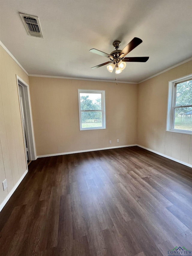 empty room featuring ceiling fan, dark hardwood / wood-style flooring, and ornamental molding