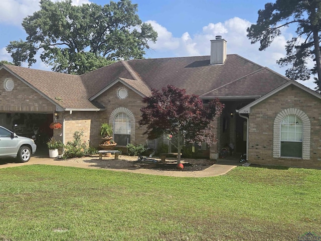 704 Cheryl St, Longview, TX 75604 - ranch-style home featuring roof with shingles, a chimney, a front lawn, and brick siding