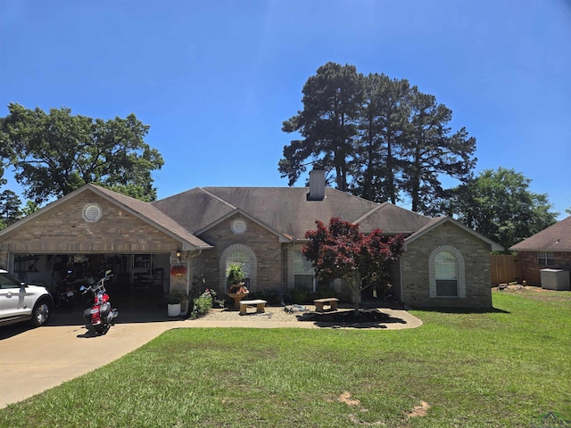 704 Cheryl St, Longview, TX 75604 - view of front of house featuring a chimney, a front yard, a garage, brick siding, and concrete driveway