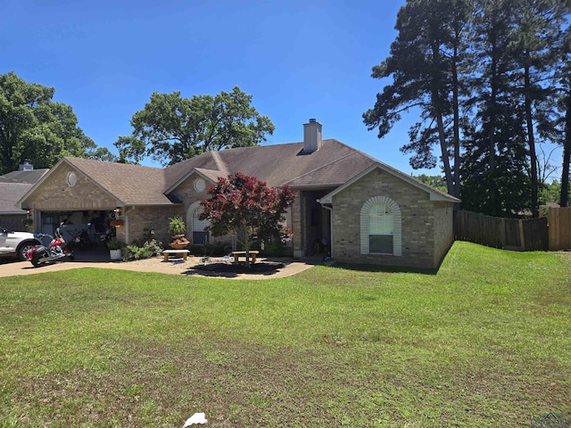 704 Cheryl St, Longview, TX 75604 - view of front facade featuring a garage, fence, a front yard, a chimney, and brick siding