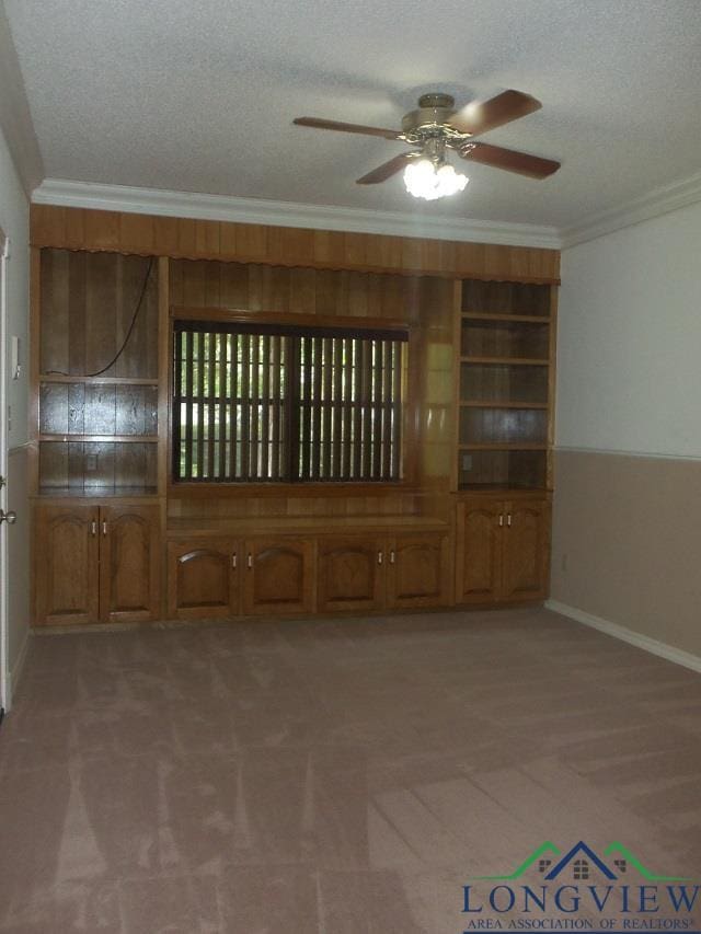 404 Moccasin Trl, Kilgore, TX 75662 - empty room featuring light colored carpet, ornamental molding, ceiling fan, and a textured ceiling