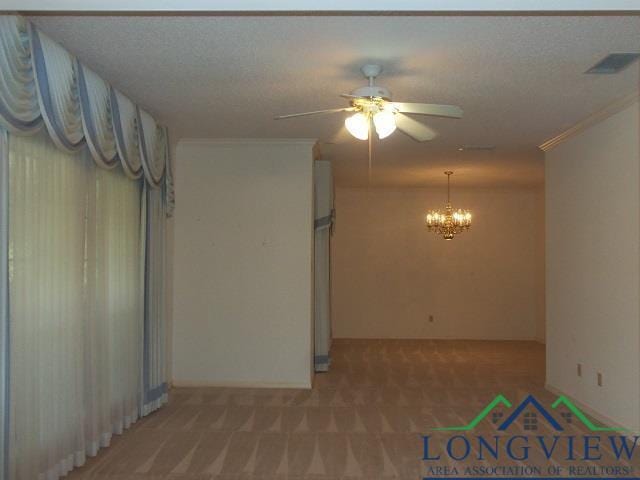 404 Moccasin Trl, Kilgore, TX 75662 - empty room featuring a ceiling fan, a chandelier, light carpet, and ornamental molding