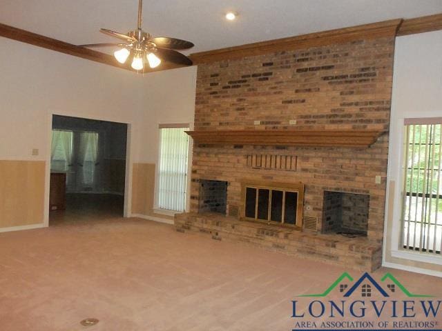 404 Moccasin Trl, Kilgore, TX 75662 - unfurnished living room with a fireplace, ceiling fan, baseboards, carpet flooring, and crown molding