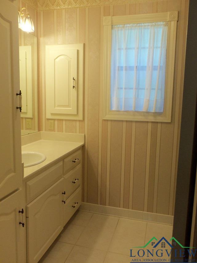 404 Moccasin Trl, Kilgore, TX 75662 - bathroom with vanity and tile patterned flooring