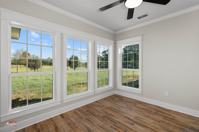 unfurnished sunroom featuring ceiling fan