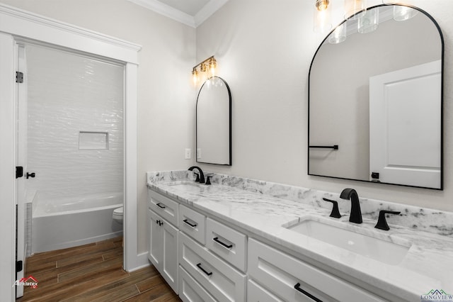 full bathroom featuring washtub / shower combination, toilet, vanity, and ornamental molding