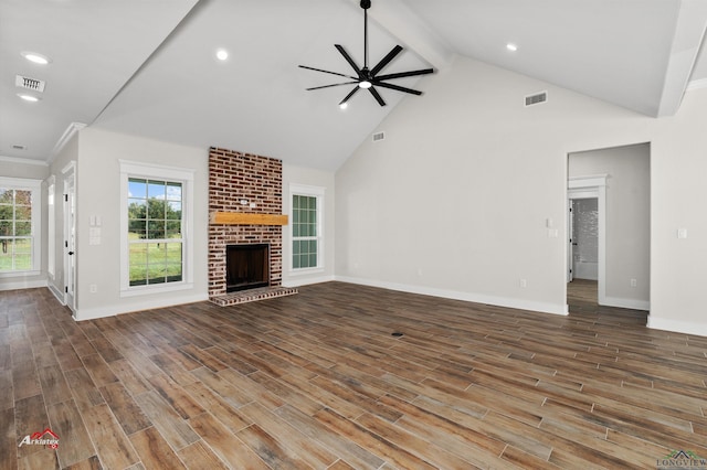 unfurnished living room featuring a fireplace, vaulted ceiling with beams, and ceiling fan