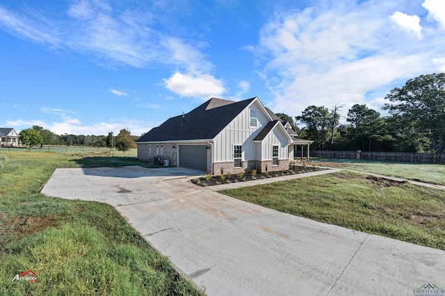 view of side of home with a yard and a garage