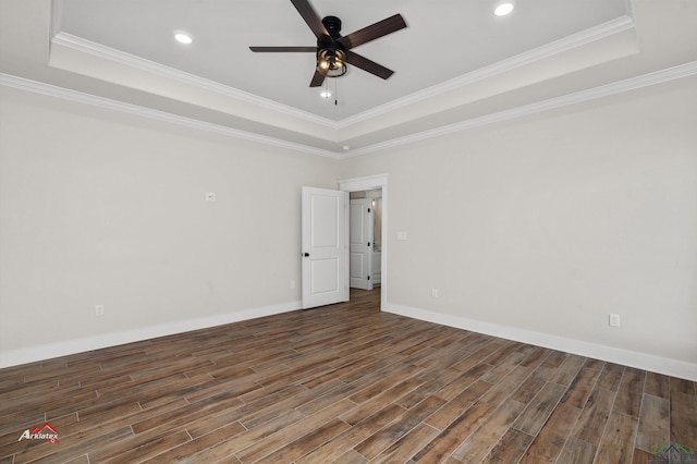 spare room with ceiling fan, ornamental molding, and a tray ceiling