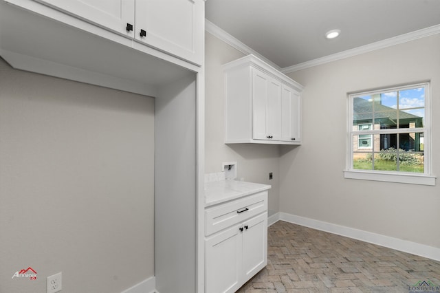 laundry room with cabinets, hookup for a washing machine, hookup for an electric dryer, and ornamental molding